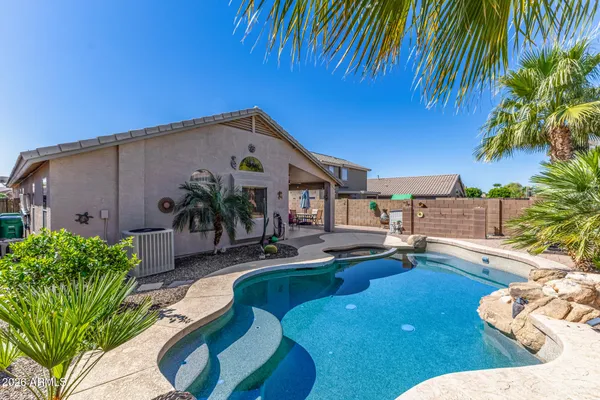 a view of a backyard with plants and a patio