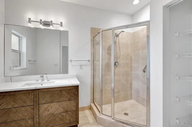 a bathroom with a shower sink and mirror