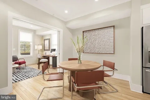 a dining room with furniture and wooden floor