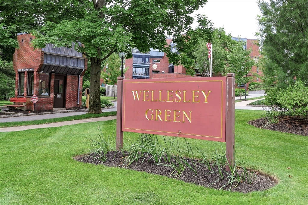 75 Grove Street, Unit 124 Wellesley, MA 02482 - Photo 1 of 22 a sign on the side of the road