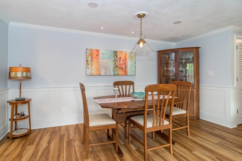 75 Grove Street, Unit 124 Wellesley, MA 02482 - Photo 11 of 22 a view of a dining room with furniture and wooden floor