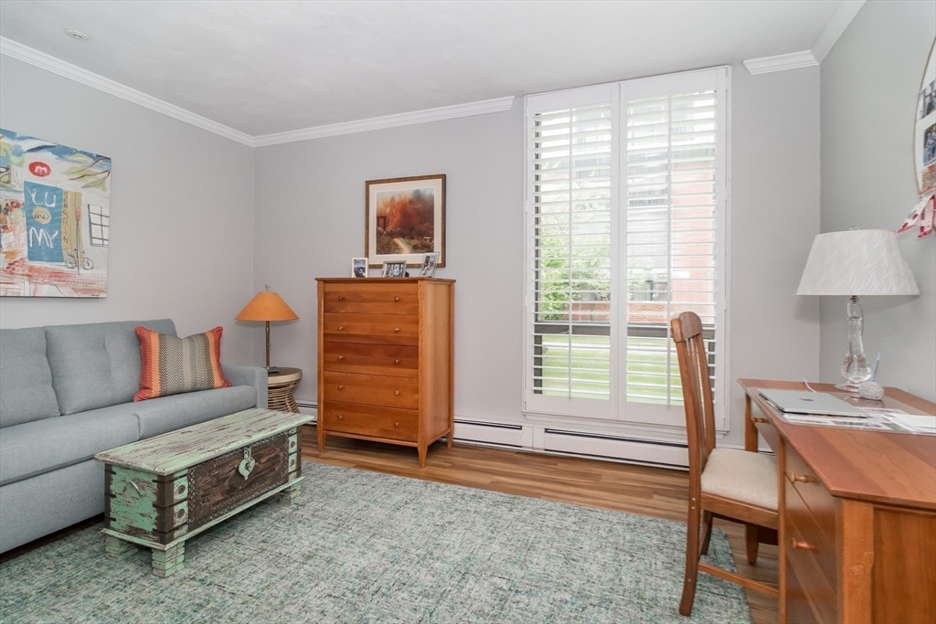 75 Grove Street, Unit 124 Wellesley, MA 02482 - Photo 12 of 22 a living room with furniture and a window