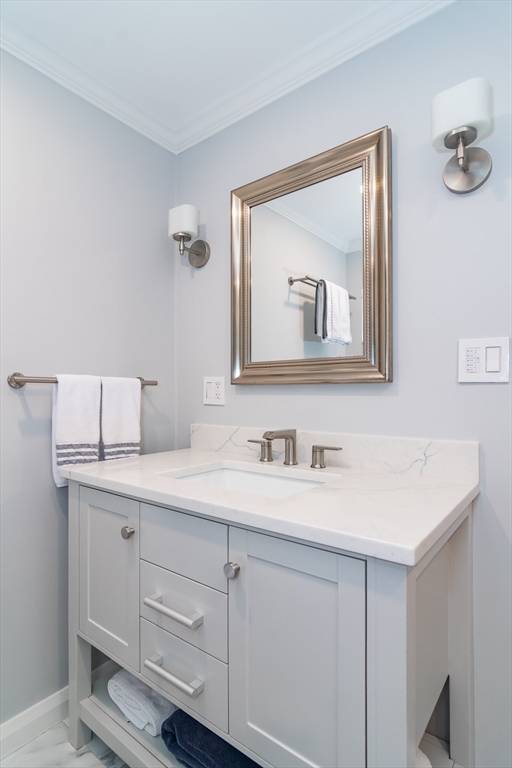 75 Grove Street, Unit 124 Wellesley, MA 02482 - Photo 14 of 22 a bathroom with a sink and a mirror