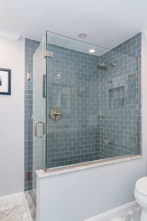 75 Grove Street, Unit 124 Wellesley, MA 02482 - Photo 15 of 22 a bathroom with a shower and a toilet