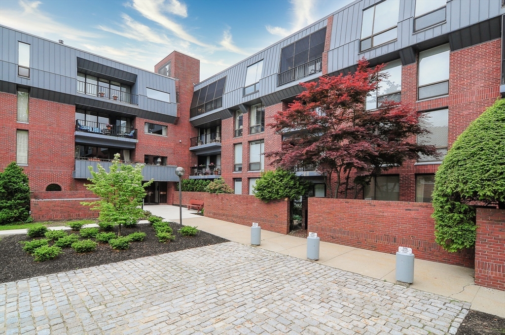 75 Grove Street, Unit 124 Wellesley, MA 02482 - Photo 2 of 22 a view of building with yard