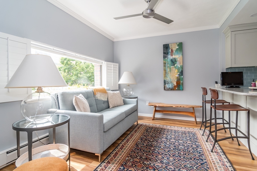 75 Grove Street, Unit 124 Wellesley, MA 02482 - Photo 7 of 22 a living room with furniture and a flat screen tv