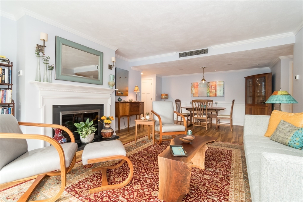 75 Grove Street, Unit 124 Wellesley, MA 02482 - Photo 8 of 22 a living room with furniture and a fireplace