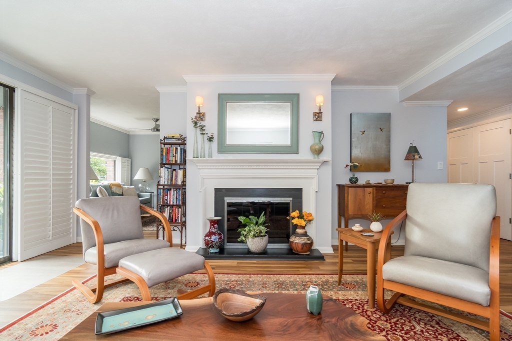 75 Grove Street, Unit 124 Wellesley, MA 02482 - Photo 10 of 22 a living room with furniture and a fireplace