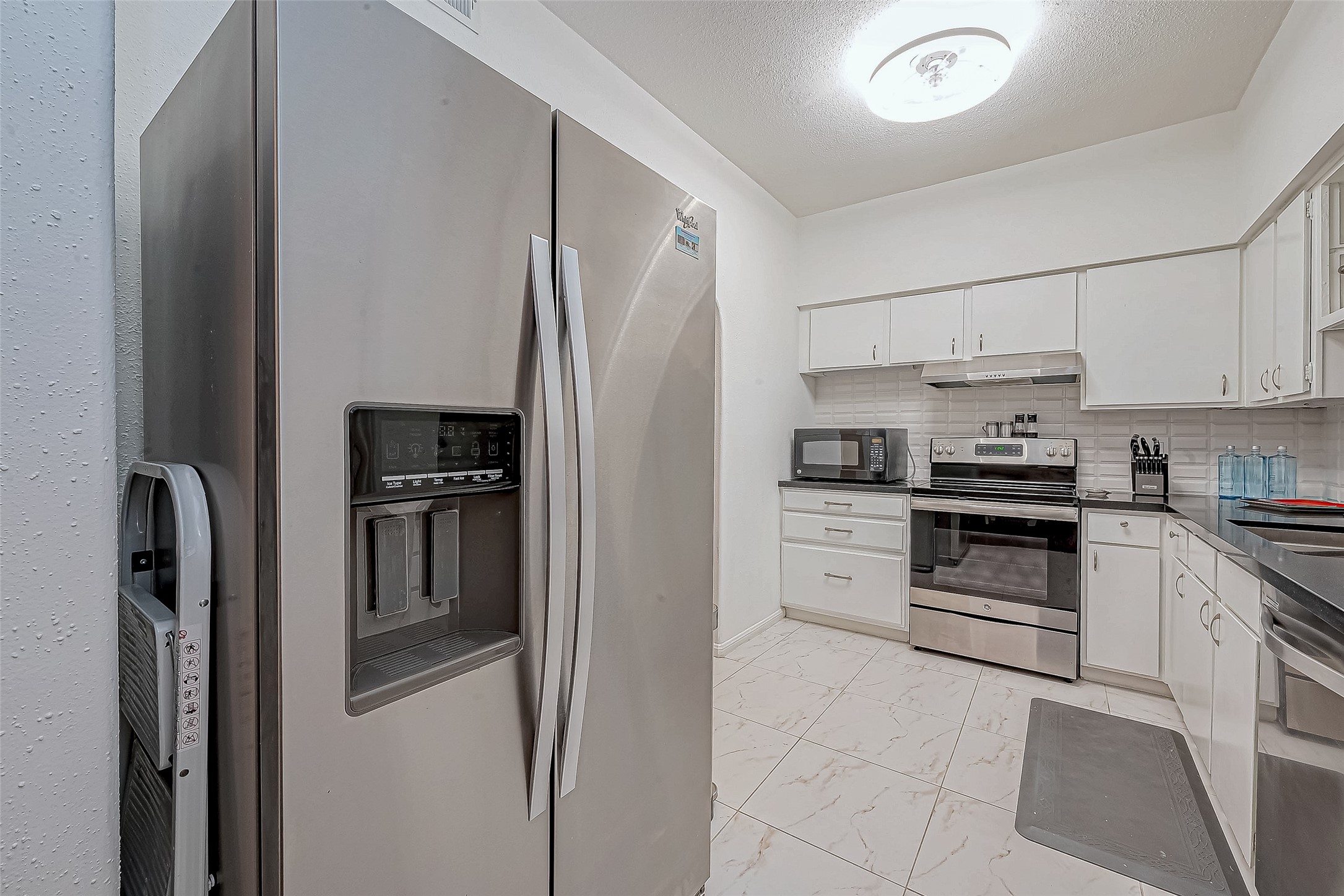 2100 Tanglewilde Street, Unit 189 Houston, TX 77063 - Photo 13 of 31 Nice updated kitchen with Refrigerator and New Lighting fixture with Fan