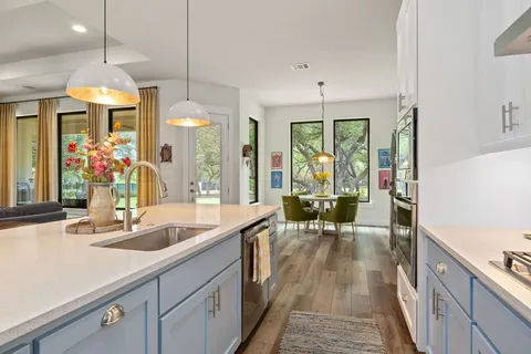a view of a kitchen with granite countertop a large island in the center