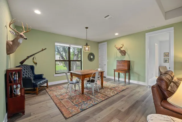 a living room with furniture a rug and a chandelier
