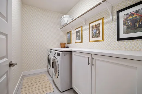 a bedroom with a large bed tv and a window
