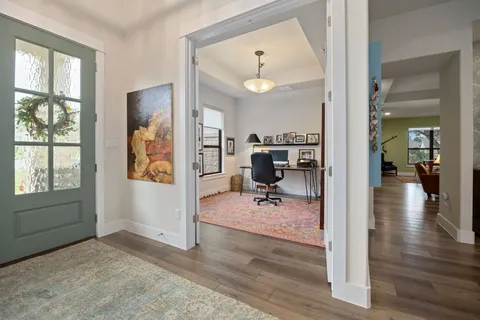 a view of a livingroom and workspace and a window