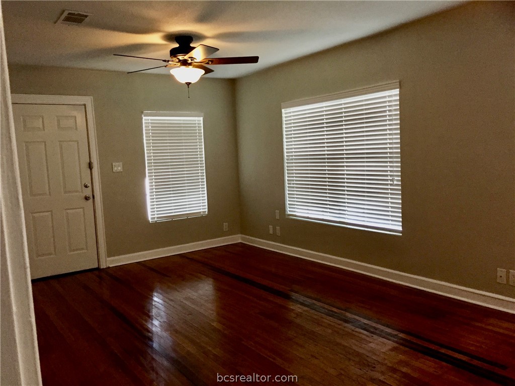 800 Mitchell Street Bryan, TX 77802 - Photo 2 of 6 Cozy living room with hardwood floors throughout