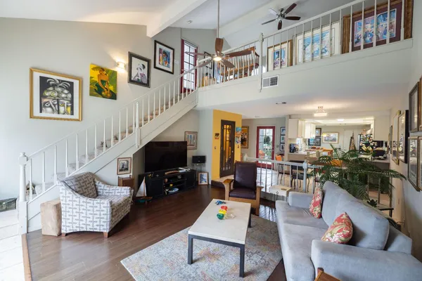 a kitchen with stainless steel appliances granite countertop a sink counter space cabinets and a couch