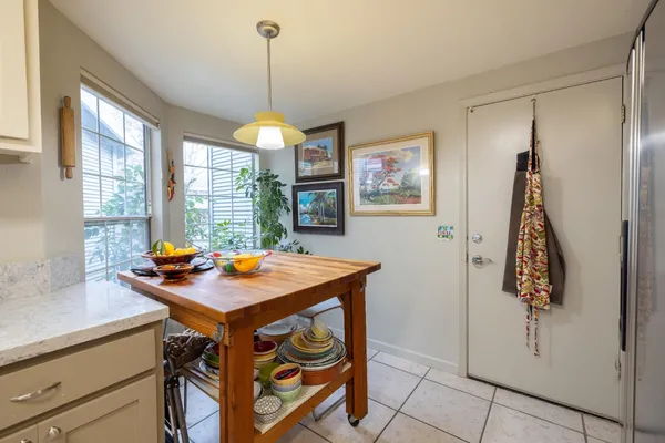 a living room with furniture kitchen view and a window