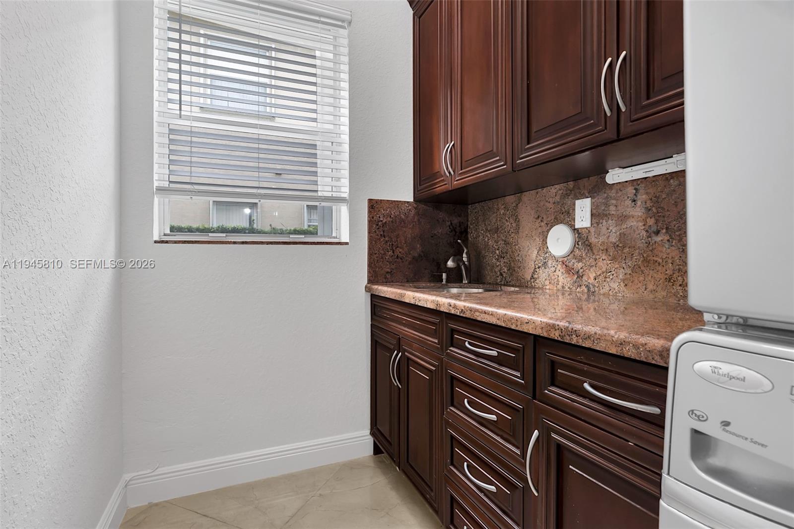 17809 Southwest 54th Street Miramar, FL 33029 - Photo 17 of 94 a kitchen with granite countertop cabinets stainless steel appliances and a sink