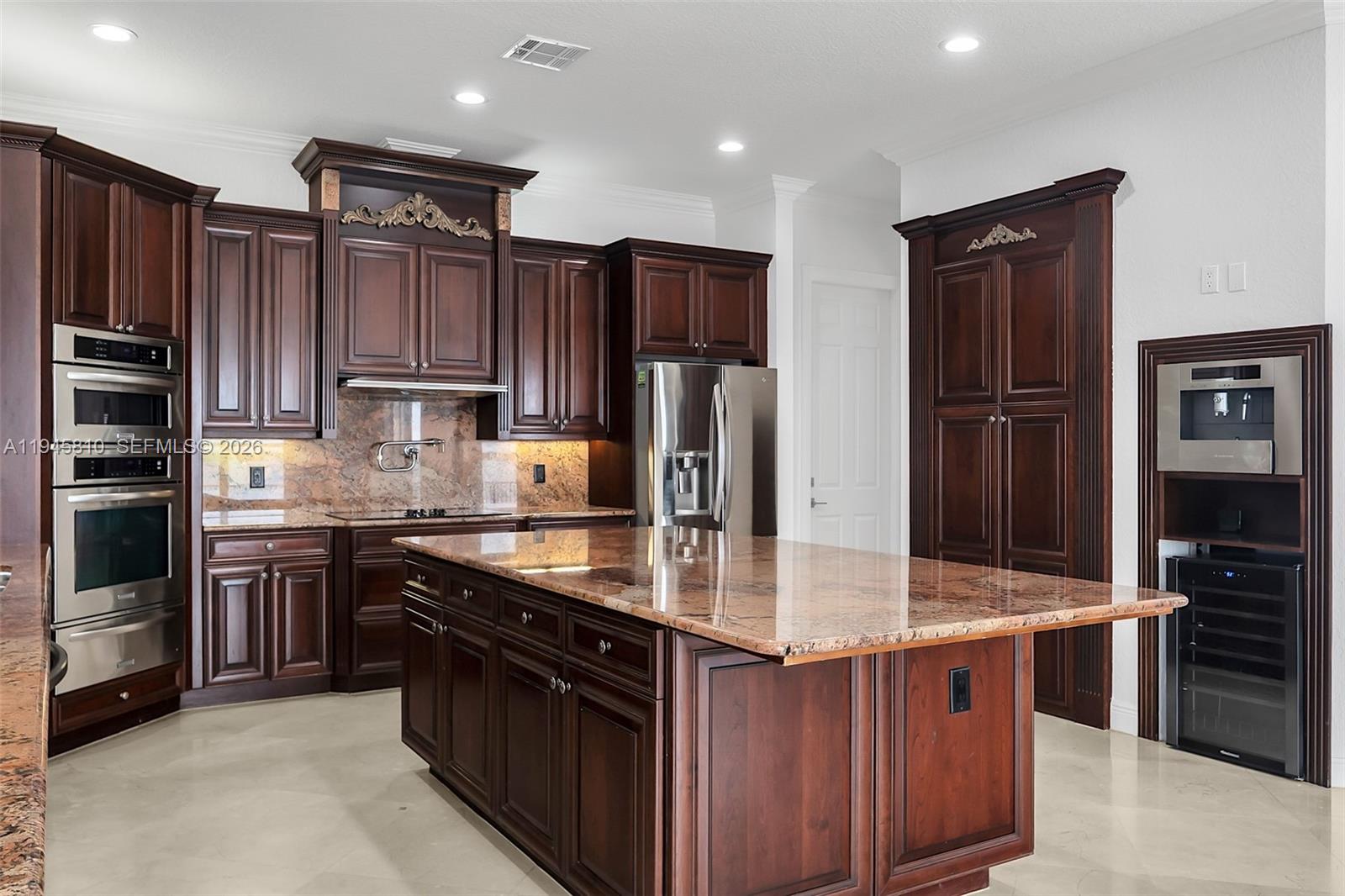 17809 Southwest 54th Street Miramar, FL 33029 - Photo 26 of 94 a large kitchen with stainless steel appliances granite countertop a stove refrigerator and cabinets