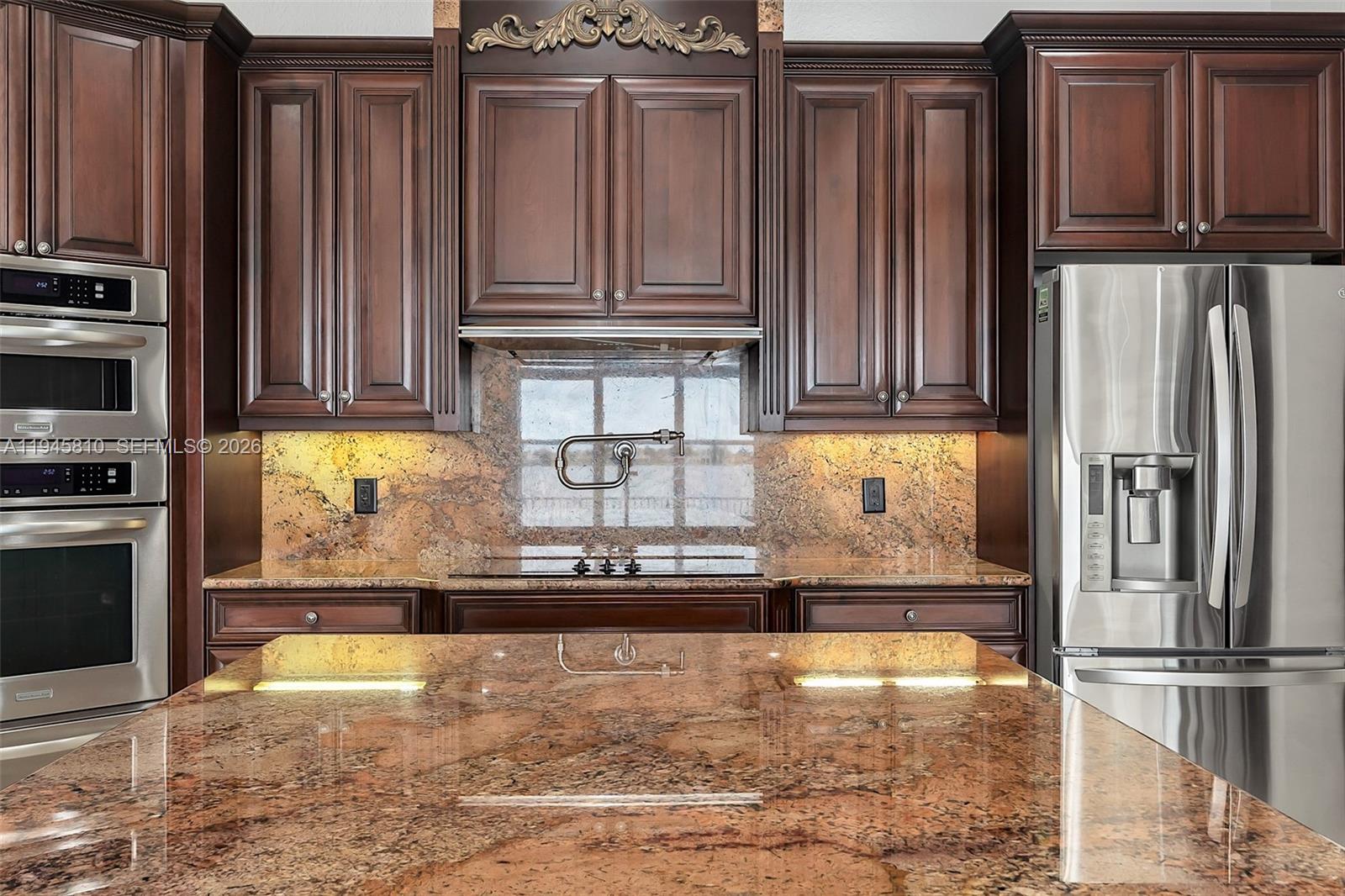 17809 Southwest 54th Street Miramar, FL 33029 - Photo 27 of 94 a kitchen with stainless steel appliances granite countertop a refrigerator and a stove top oven