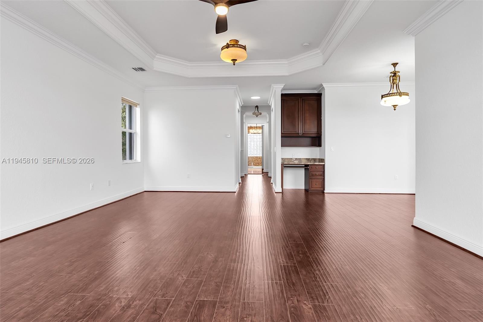 17809 Southwest 54th Street Miramar, FL 33029 - Photo 46 of 94 a view of an empty room and window with wooden floor