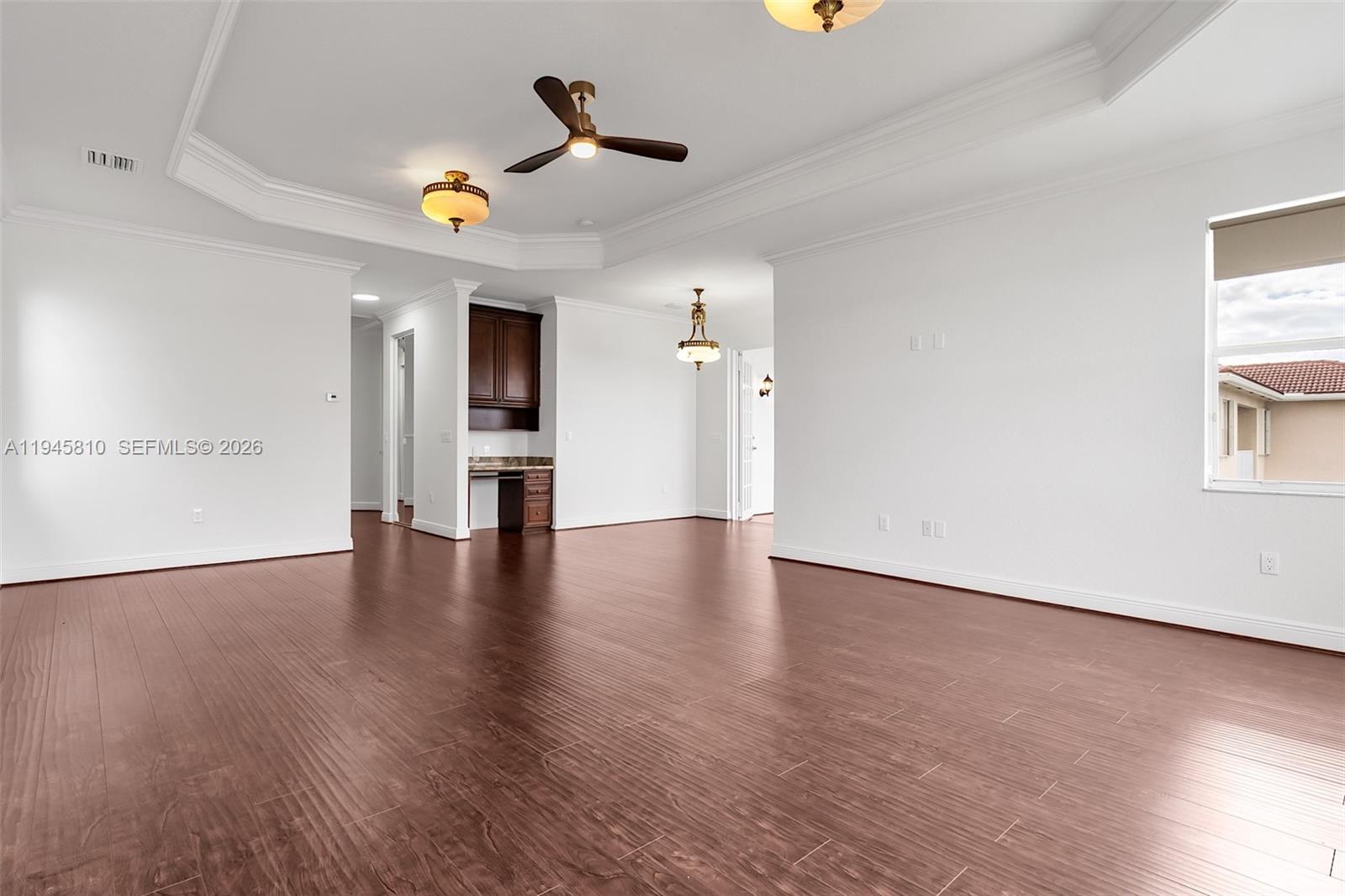 17809 Southwest 54th Street Miramar, FL 33029 - Photo 47 of 94 a view of a livingroom with wooden floor and a ceiling fan