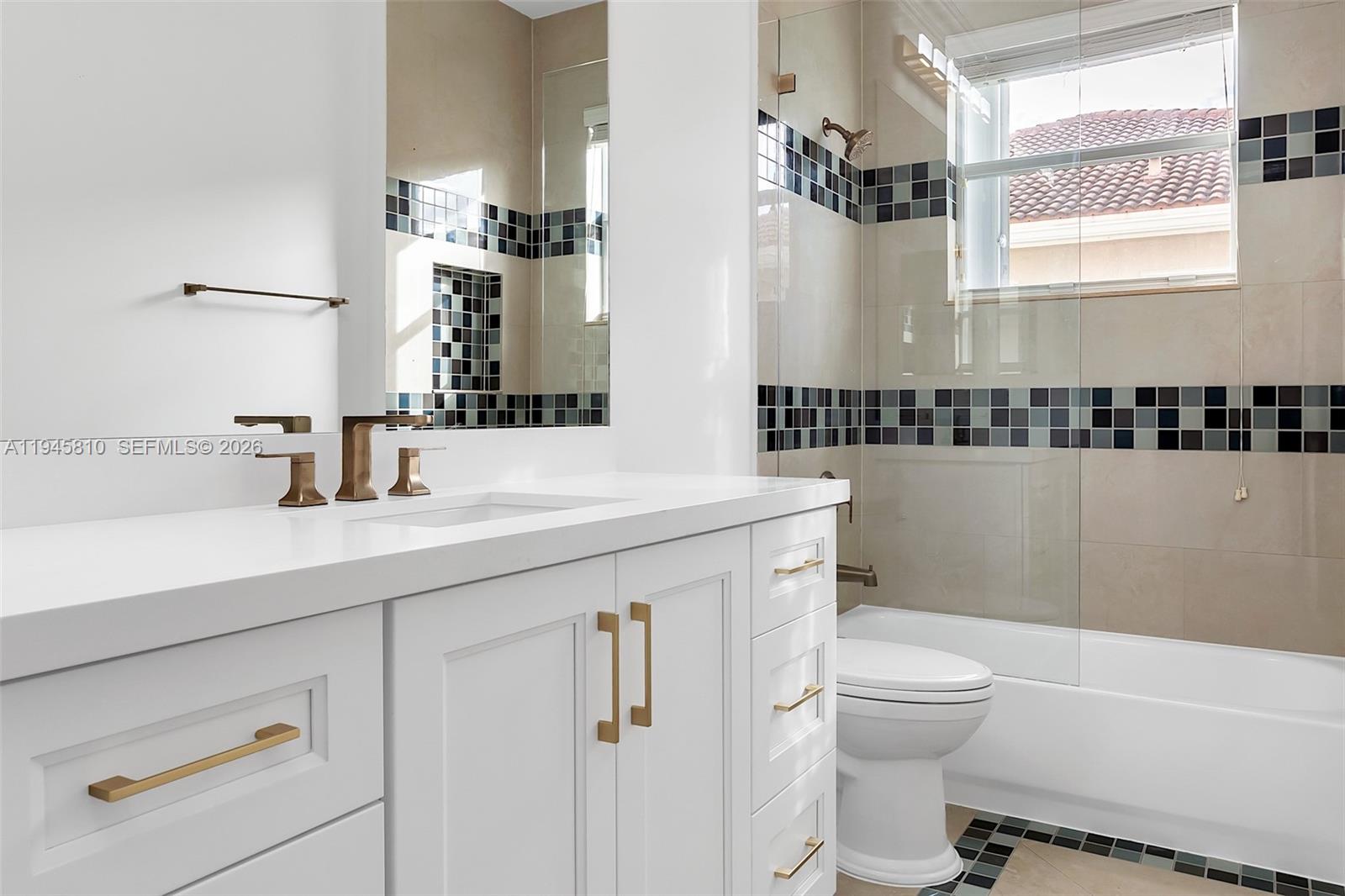 17809 Southwest 54th Street Miramar, FL 33029 - Photo 62 of 94 a bathroom with a sink a toilet a mirror and shower