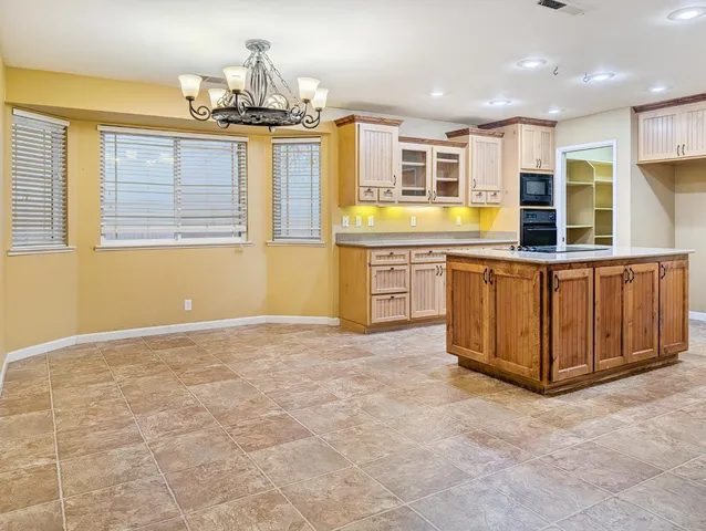 a view of a kitchen with stainless steel appliances granite countertop a stove and a sink