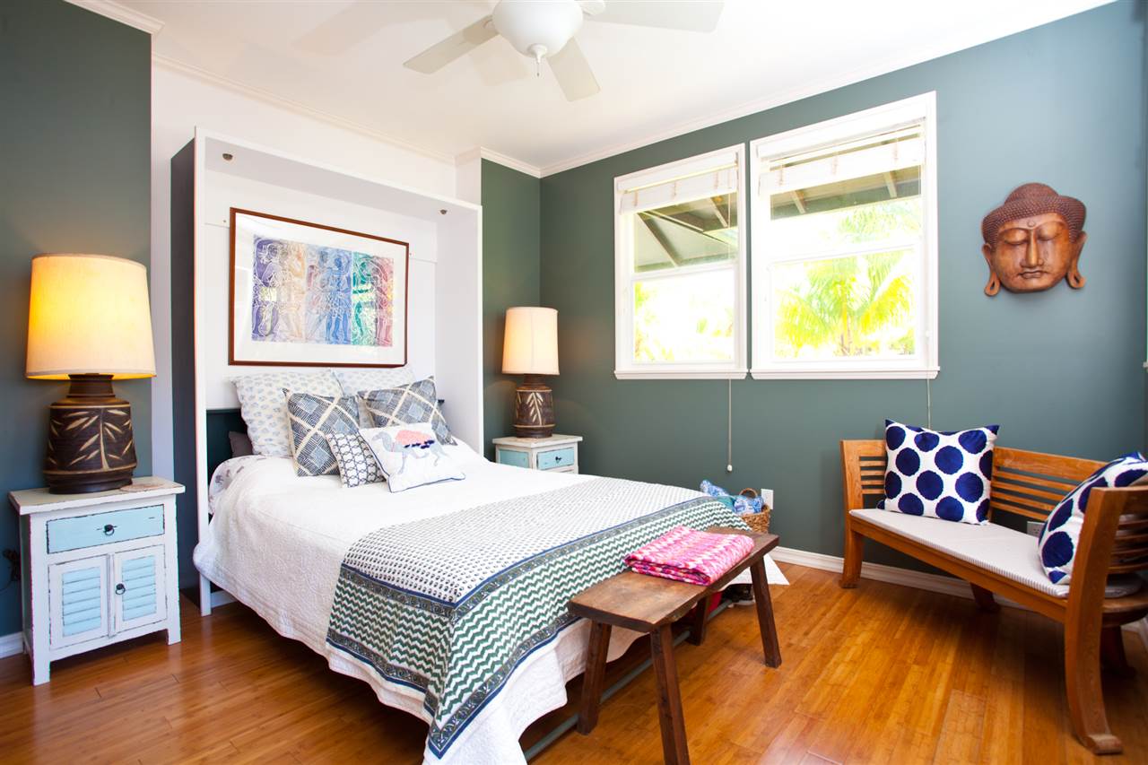 160 Nahele Road Haiku, HI 96708 - Photo 23 of 30 a bedroom with a bed and wooden floor