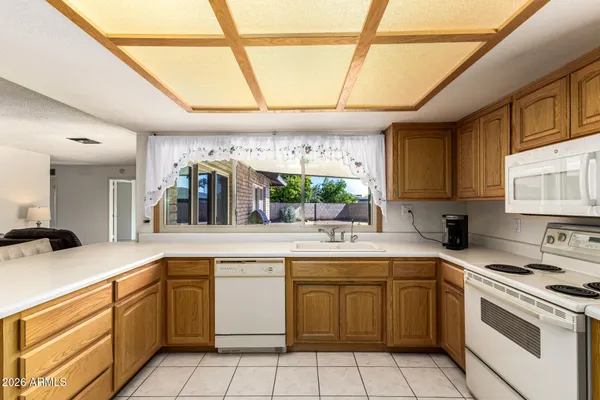 a kitchen with a sink window and cabinets