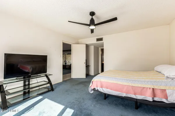 a bedroom with a bed and a flat screen tv