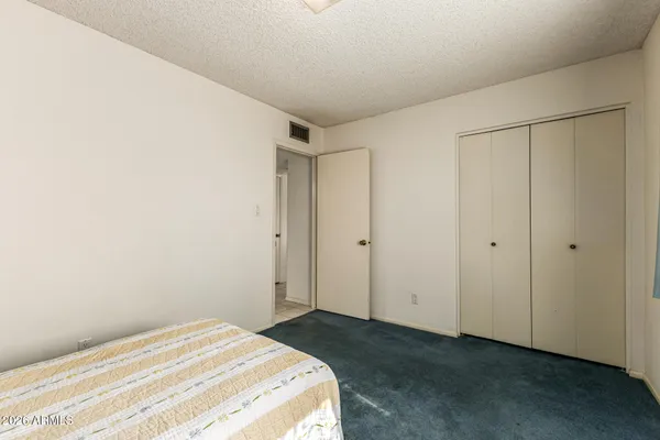 a bedroom with a bed and a shower