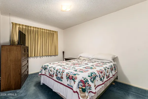 a bedroom with a bed and window