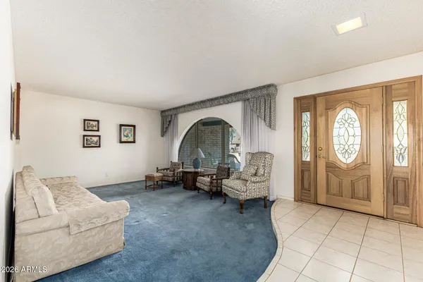 a living room with furniture and a clock