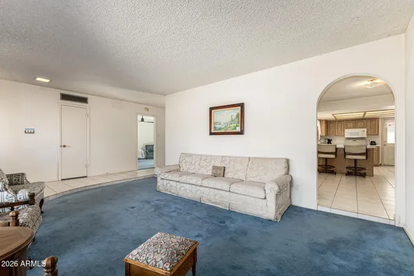 a living room with furniture and a mirror