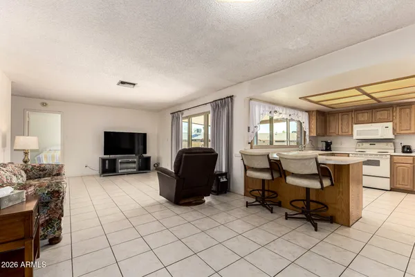 a view of a livingroom with workspace and a window