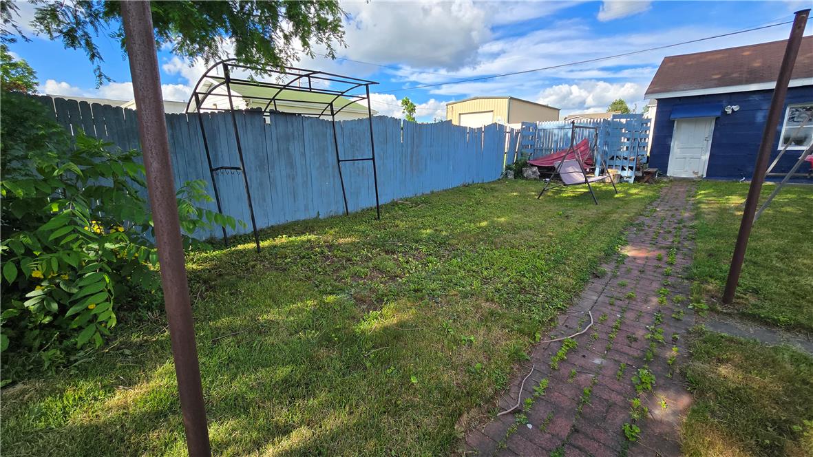 883 North Locust Street Hazleton, PA 18201 - Photo 30 of 83 A private yard with a picket fence offers a secluded outdoor space.