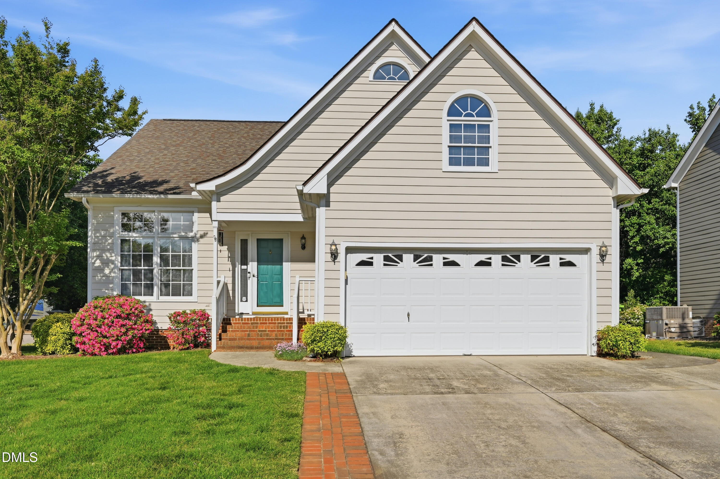 6801 Lynnoak Drive Raleigh, NC 27613 - Photo 1 of 30 a front view of a house with a garden and plants