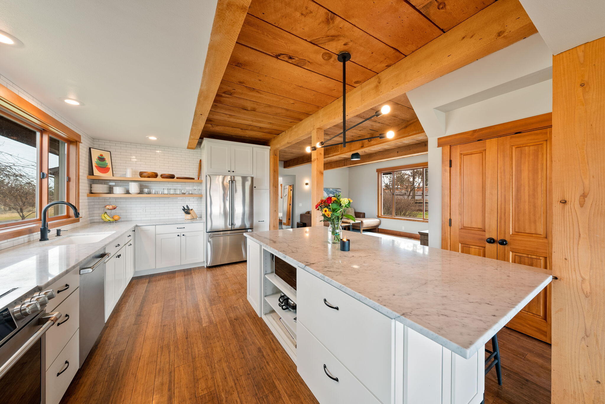 65345 Tweed Road Bend, OR 97703 - Photo 19 of 90 a large kitchen with kitchen island a large counter space a sink appliances and cabinets