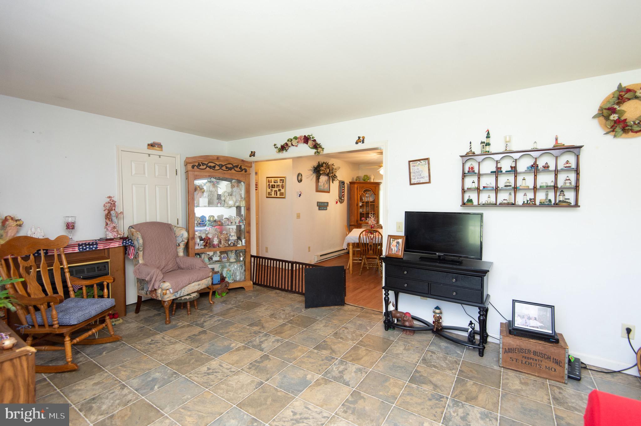 5834 Bell Creek Road Preston, MD 21655 - Photo 11 of 44 a living room with furniture and a flat screen tv
