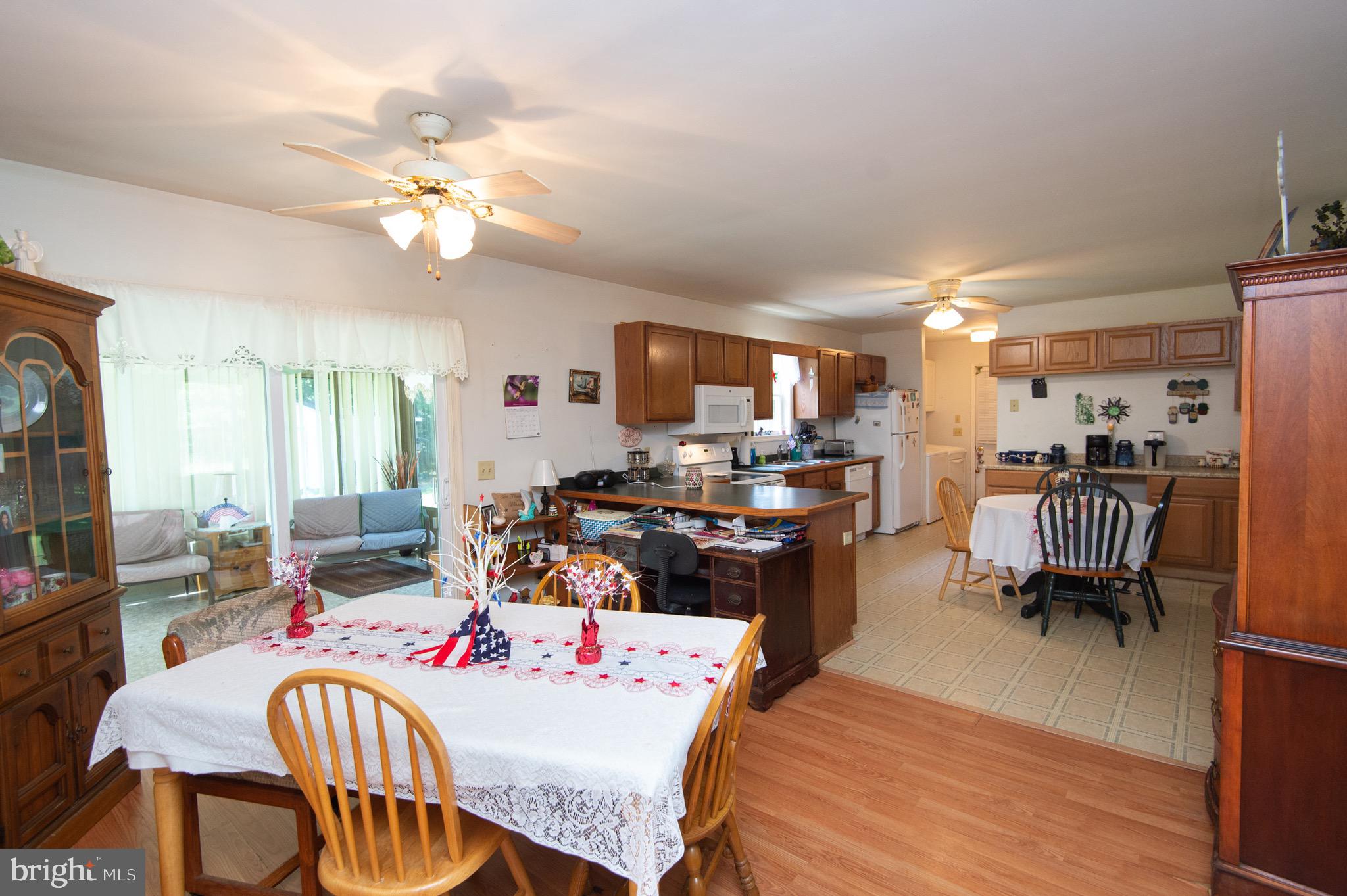 5834 Bell Creek Road Preston, MD 21655 - Photo 13 of 44 a living room with furniture a flat screen tv and kitchen view
