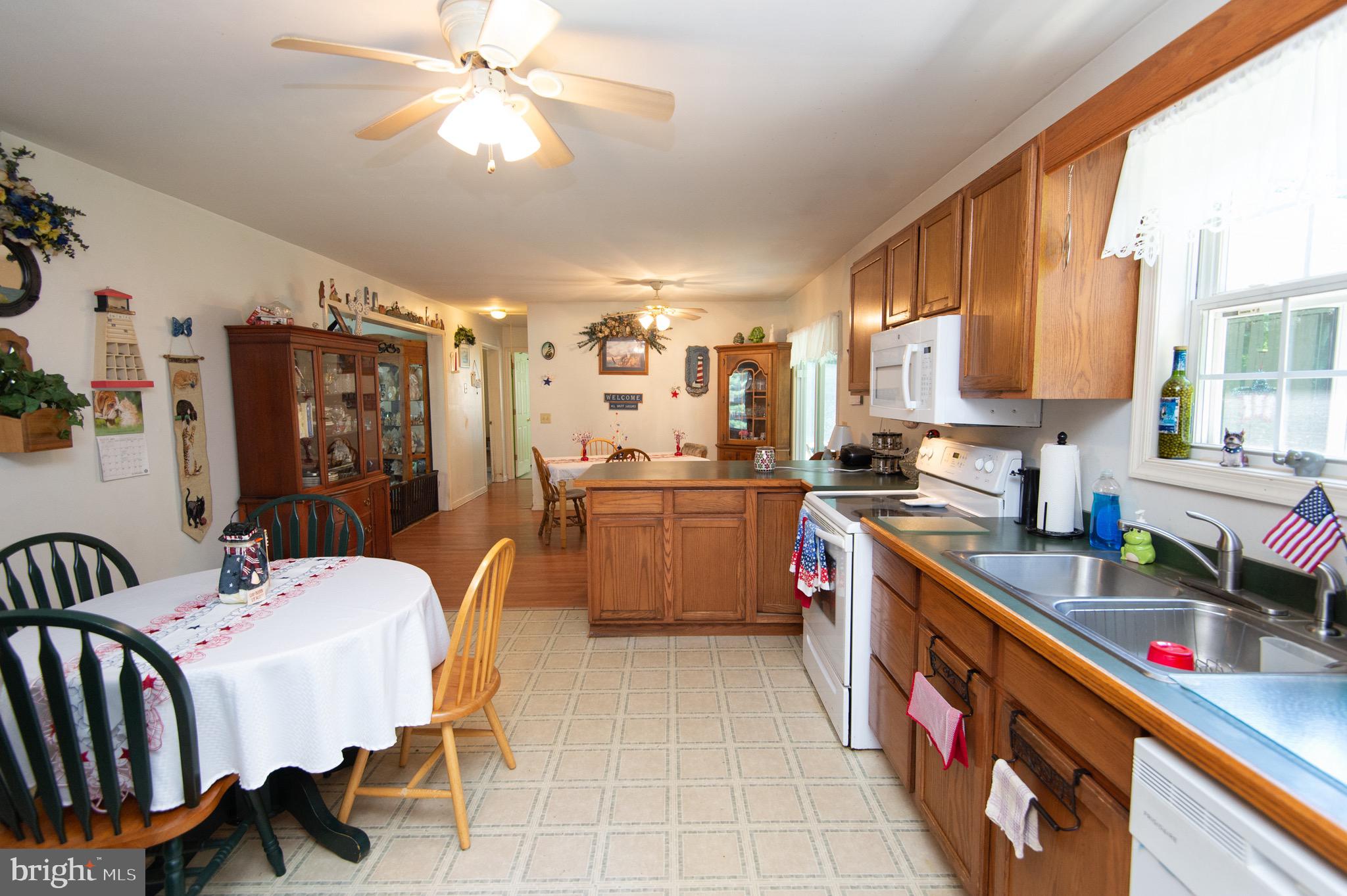5834 Bell Creek Road Preston, MD 21655 - Photo 17 of 44 a kitchen that has a lot of furniture and appliances