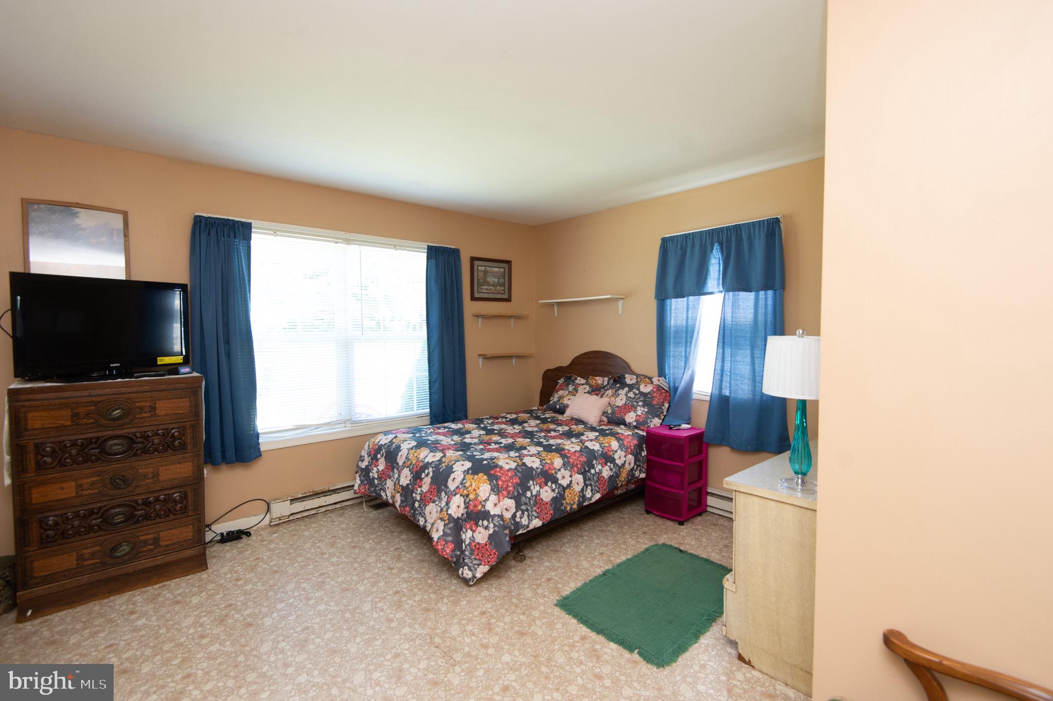 5834 Bell Creek Road Preston, MD 21655 - Photo 20 of 44 a bedroom with a bed television on desk and a window