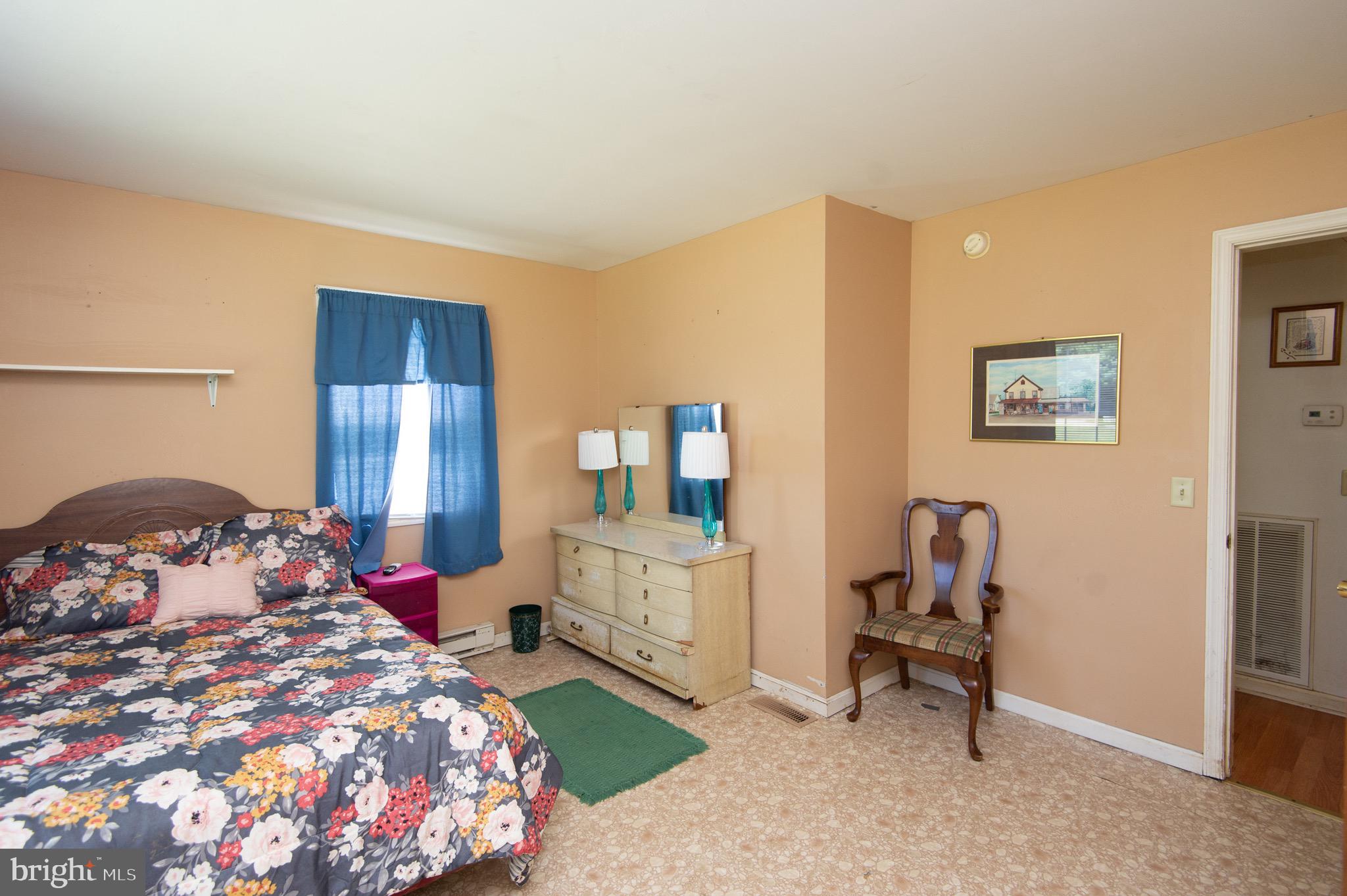 5834 Bell Creek Road Preston, MD 21655 - Photo 21 of 44 a bedroom with a bed a desk and chair