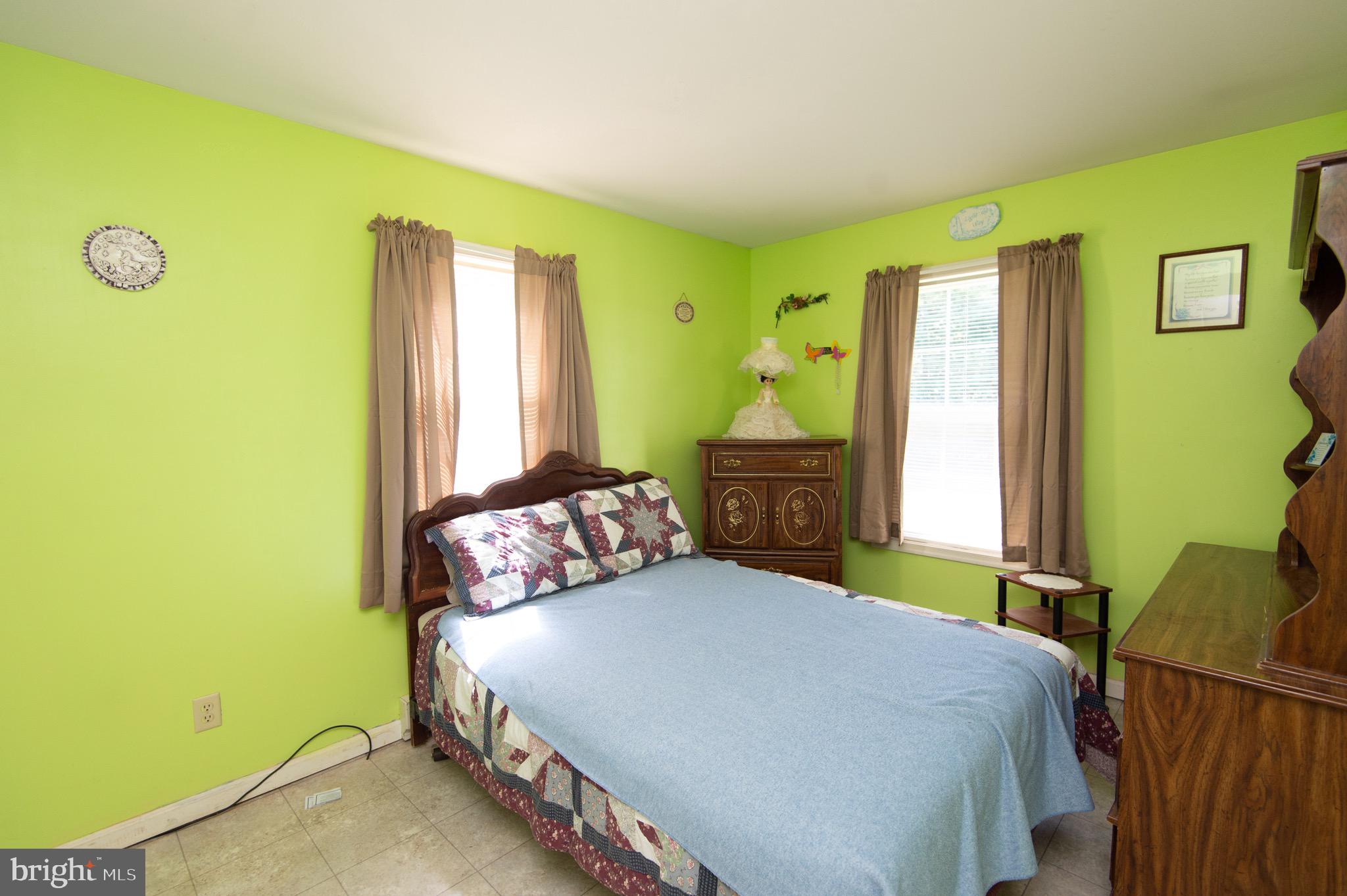 5834 Bell Creek Road Preston, MD 21655 - Photo 23 of 44 a bedroom with a bed and a window