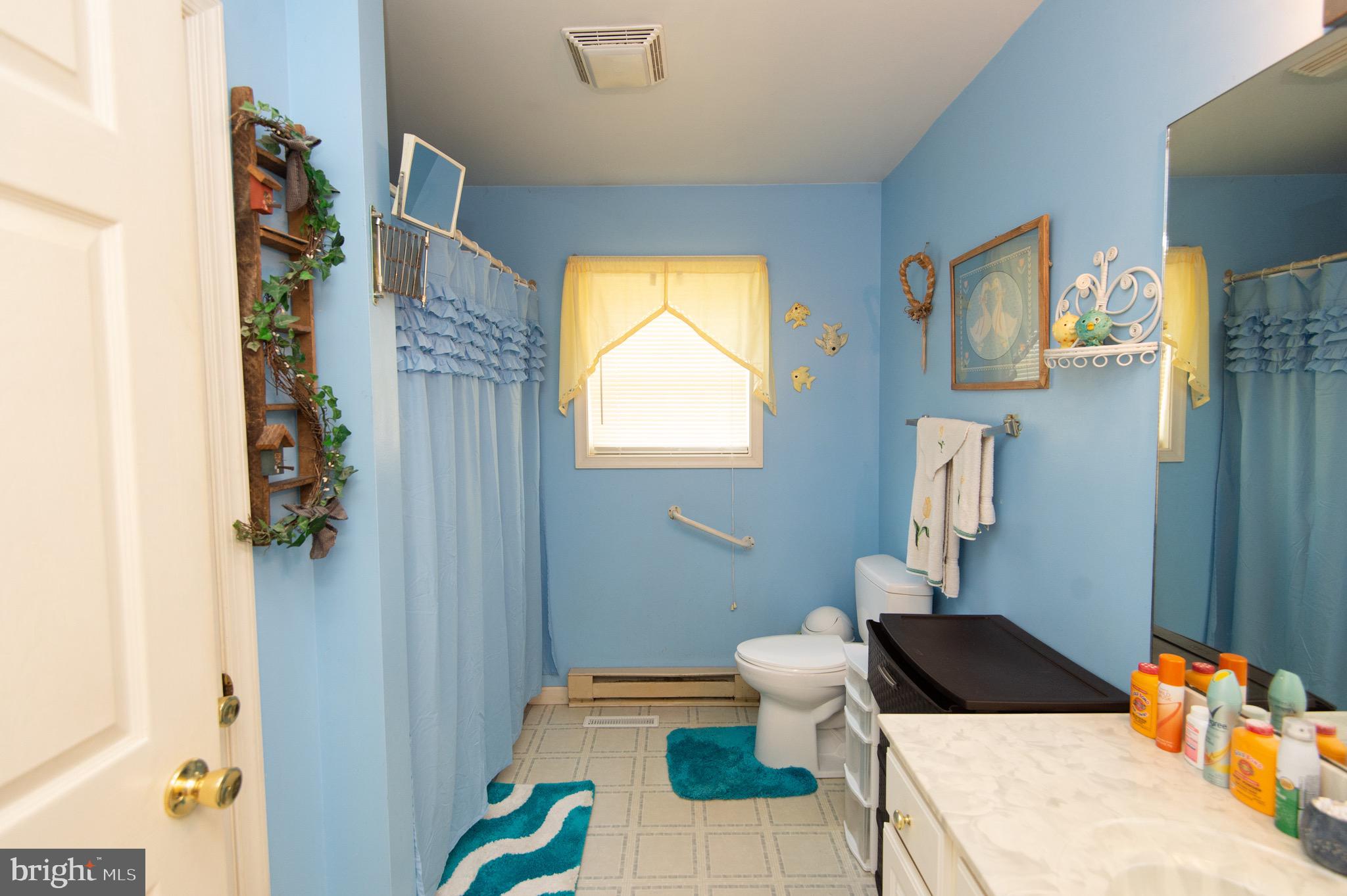 5834 Bell Creek Road Preston, MD 21655 - Photo 25 of 44 a bath room with a bed and a window
