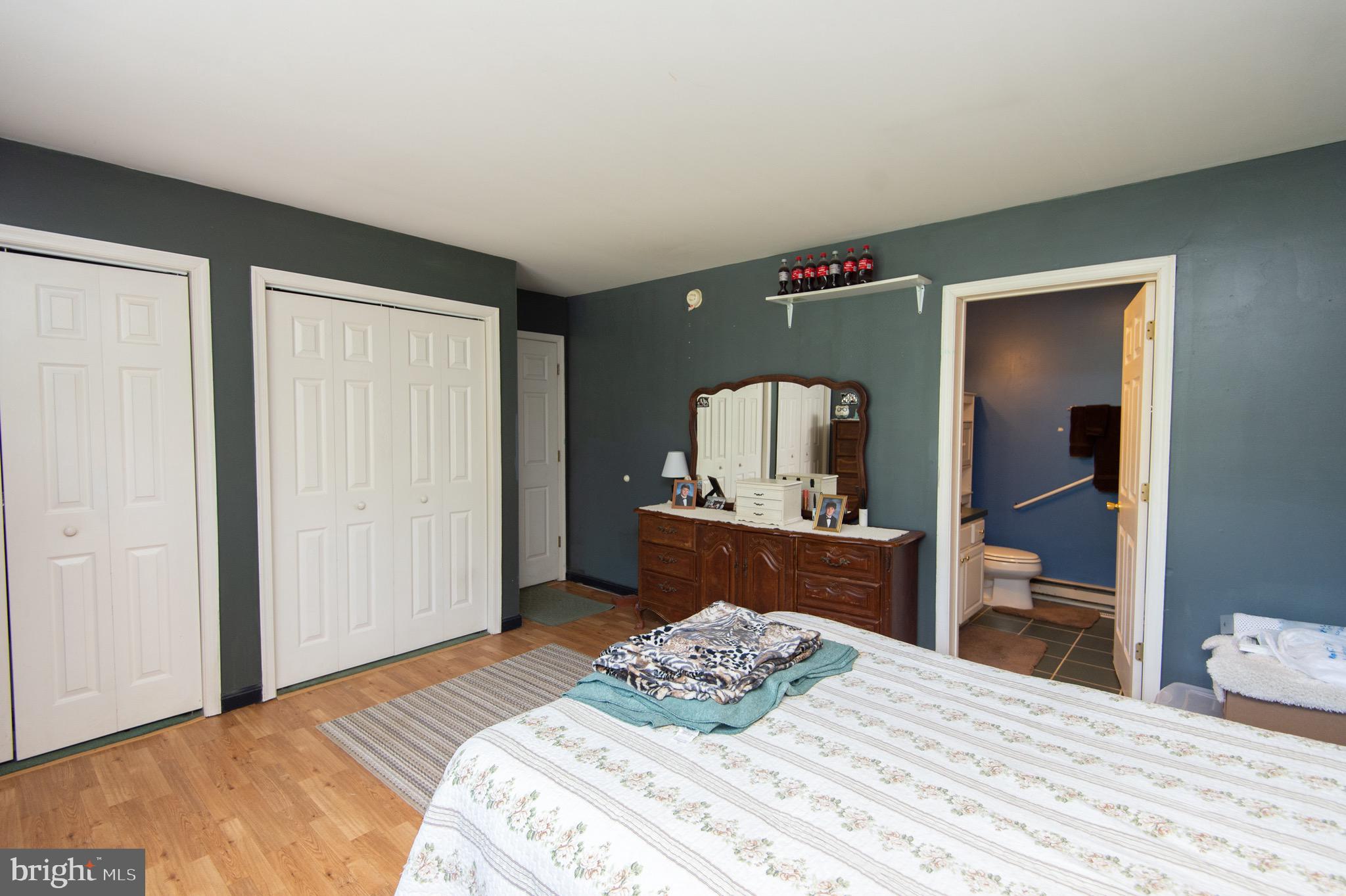 5834 Bell Creek Road Preston, MD 21655 - Photo 29 of 44 a bedroom with a bed and wooden floor