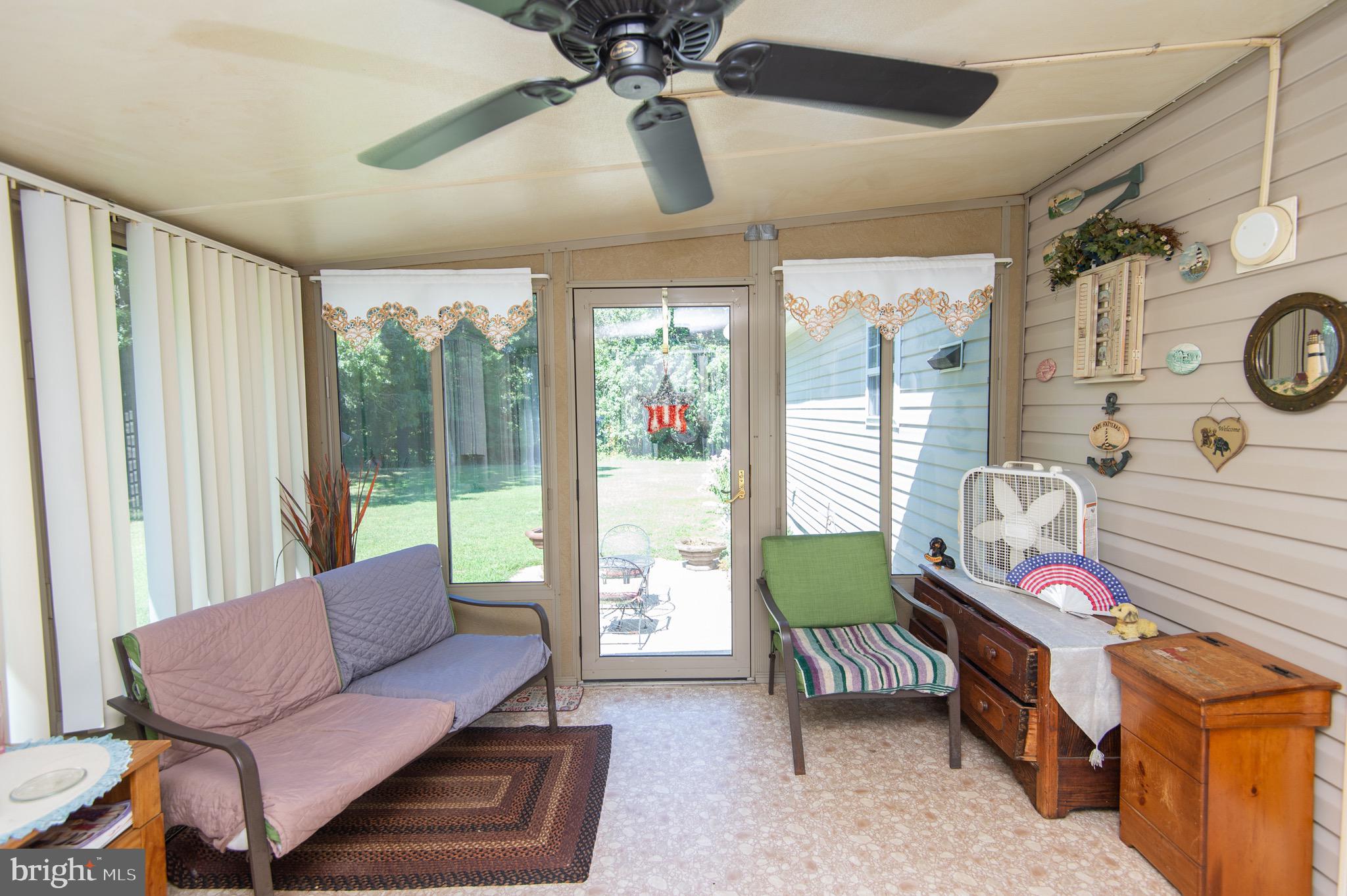5834 Bell Creek Road Preston, MD 21655 - Photo 32 of 44 a bedroom with furniture and a large window