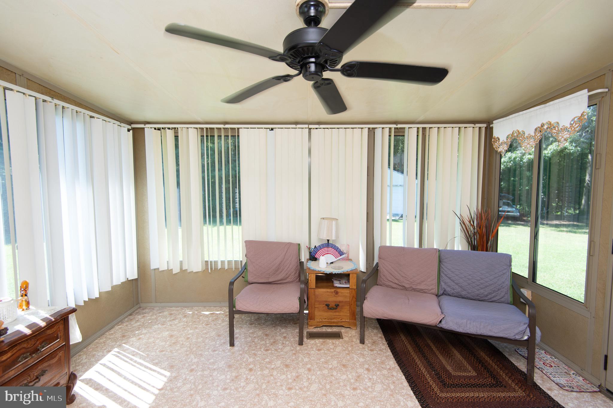 5834 Bell Creek Road Preston, MD 21655 - Photo 35 of 44 a living room with furniture and a large window