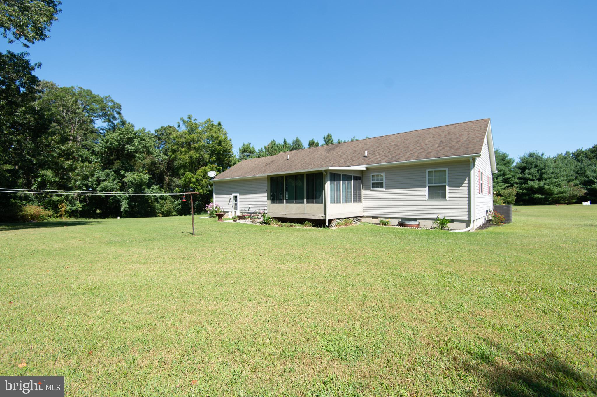 5834 Bell Creek Road Preston, MD 21655 - Photo 40 of 44 a front view of house with yard and trees in the background
