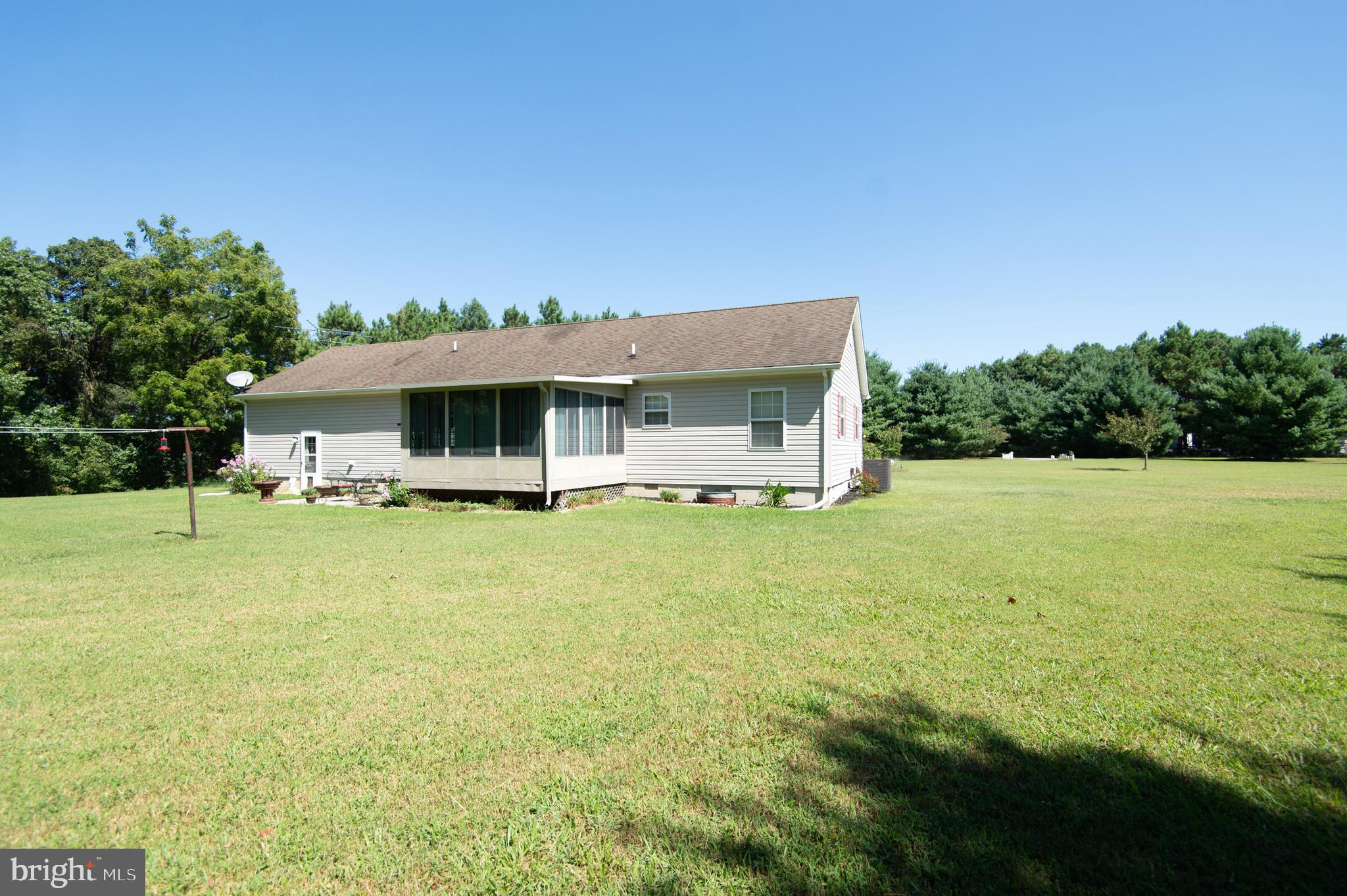 5834 Bell Creek Road Preston, MD 21655 - Photo 41 of 44 a view of a house with a garden and deck